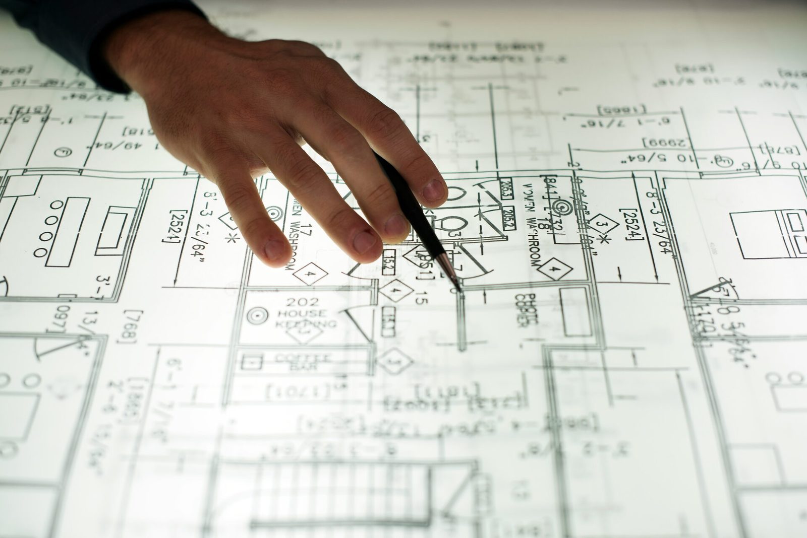 Hand reviewing construction drawings